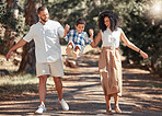 Smile, nature and happy family in a park walking and having fun as a young child plays with mother and father in USA. Love, happiness and parents enjoy quality time and bonding with kid in summer