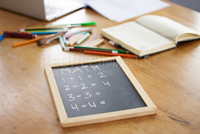Buy stock photo Chalkboard, math or notebook in homeschool study at house in covid lockdown, quarantine or social distancing. Zoom, education question or learning support for students, children or kids on wood table