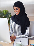 Muslim business woman using computer wearing hijab headscarf in office smiling happy