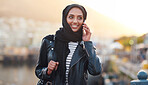 Portrait muslim woman using smartphone having phone call talking on mobile phone in city wearing hijab headscarf