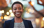 Portrait african american woman smiling confident female in city evening with lights in background