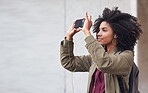 African american woman taking photo using smartphone in city female tourist photographing urban travel with mobile phone camera
