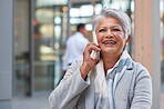 Senior business woman using smartphone talking on mobile phone in city having conversation 