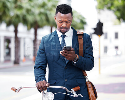 Buy stock photo Reading, texting or web search on a phone of a business man ready to ride a bike to work or home. Digital entrepreneur using 5g internet on modern technology before riding a bicycle in the city