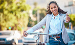 A bike, thumbs up and happy business woman taking a ride around the city for wellness or fitness. Bicycle, portrait and female rider training or cycling or on a workout for biking sports in town.