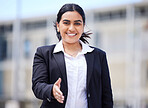 Portrait of happy business manager with handshake and smile outdoor in the city. Woman with thank you, welcome or congratulations hand gesture with agreement for a contract, partnership or promotion