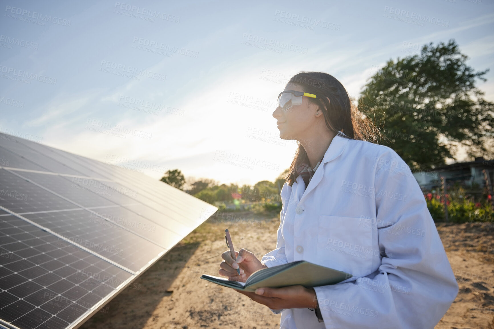 Buy stock photo Woman working in solar energy, writing research on solar panels and studying sustainability of clean energy in summer. Scientist expert doing analysis on future innovation and green electricity