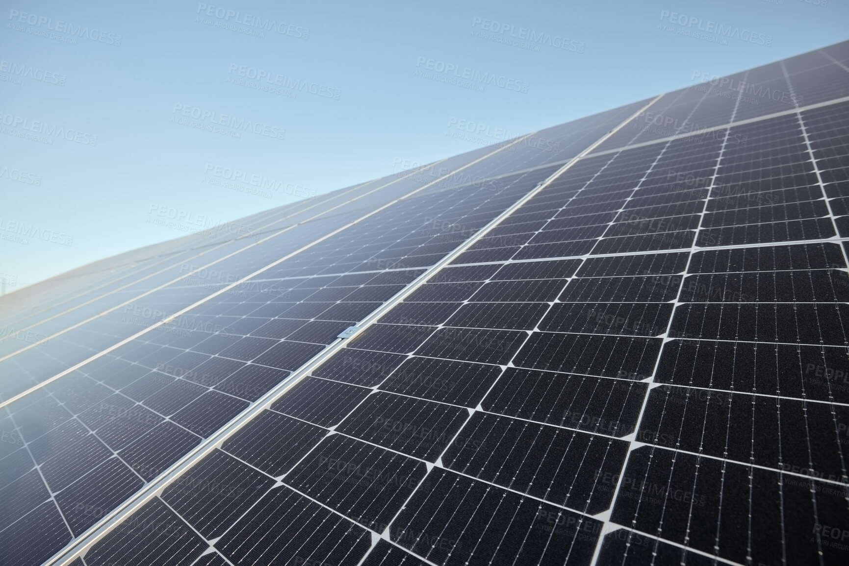 Buy stock photo Renewable, clean and green energy with solar panels for future eco electricity from the sun against a blue sky mockup. Photovoltaic power system converting sunlight through cells for sustainability