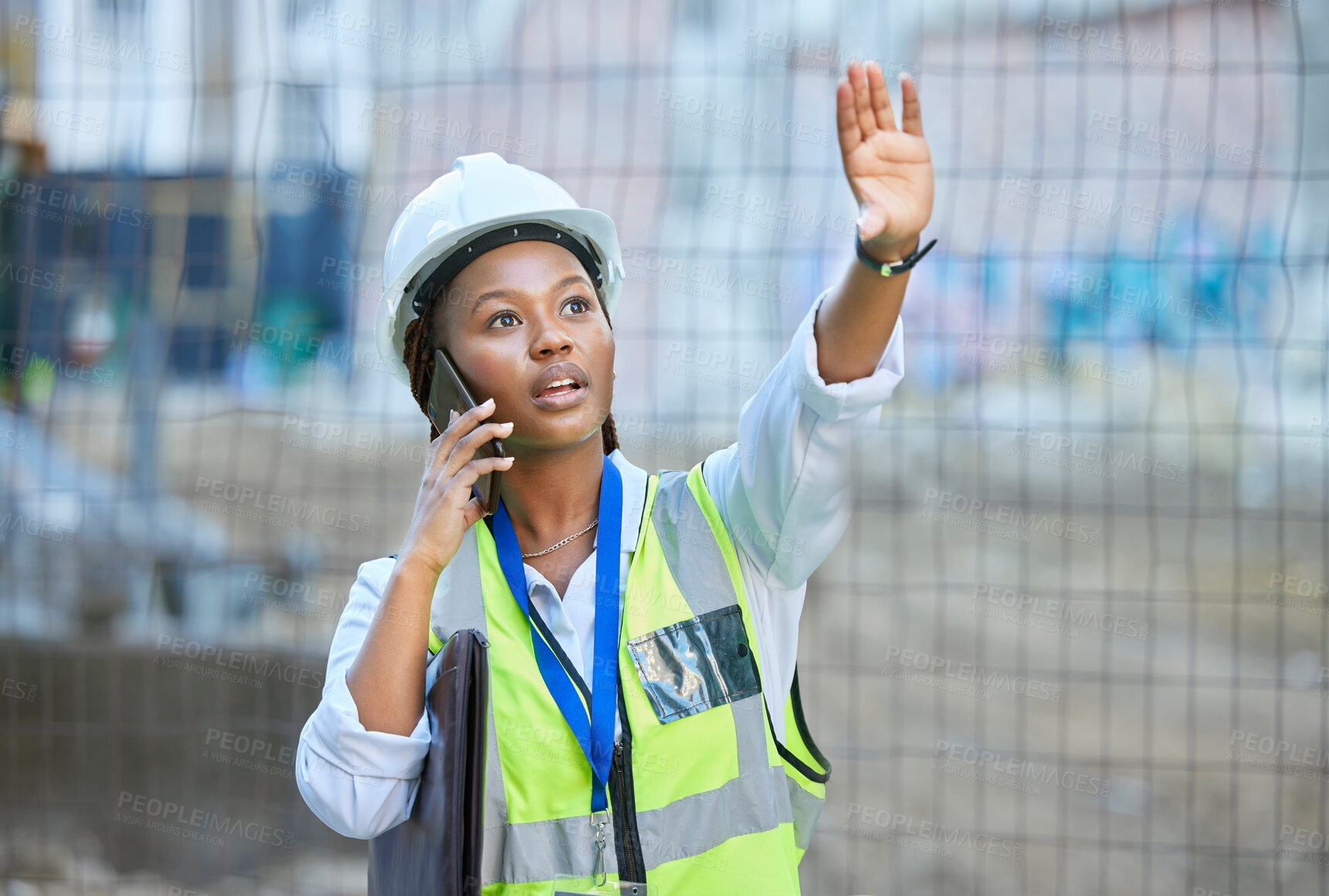 Buy stock photo Construction worker, maintenance and development woman multitask on a phone while working. Building management employee on a work call helping holding up a hand on a contractor and builder job site