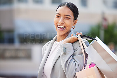 Buy stock photo Shopping, retail and sale with a young woman in the city to spend money and shop at a store or mall. Portrait of a happy, carefree and urban customer with a smile holding bags out on the town
