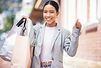 Shopping, retail and celebration of a young woman in the city, cheering, spending money and looking for a sale in the city. Enjoying a day at the shop, store or mall against an urban background