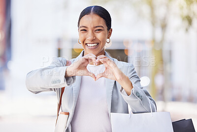 Buy stock photo Shopping woman with love and heart sign or hand in an urban city street with retail bags. Professional fashion business female, customer and designer with self care or emoji hands, portrait and smile