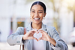 Love, heart and happy hand sign of a young female with a smile with a positive mindset and vision. Portrait of a modern business woman smiling with a hands gesture showing support, trust and care