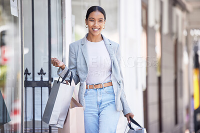 Buy stock photo Fashion, retail and shopping with happy black woman excited about a sale, carry bag while walking in a city. Smiling female looking carefree, cheerful fun downtown, positive about discount on clothes