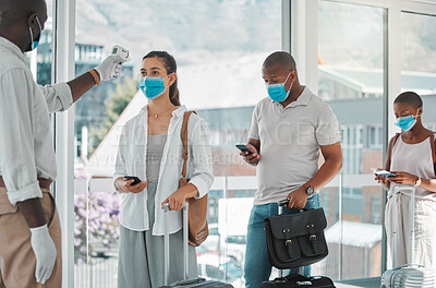 Buy stock photo Covid, travel and healthcare worker testing the temperature of people to board a flight at an airport. A nurse, health and safety with travelers in masks getting tested for corona to get on a plane.