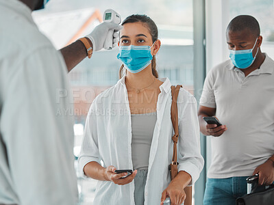 Buy stock photo Compliance, travel and covid restrictions by security scanning tourist temperature with a infrared thermometer at airport. Worker checking or fever for other corona related symptoms at work