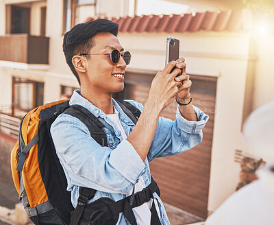 Buy stock photo Happy man tourist taking a selfie with phone on vacation, holiday or travel for online social media in summer. Asian male using mobile smartphone in a foreign urban city or town with a smile outdoor