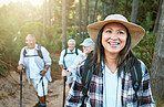 Hiking, adventure and exploring with a senior woman and her retired friends on a hike outdoors in nature. Enjoying a walk or journey of discover in the forest or woods for leisure and recreation