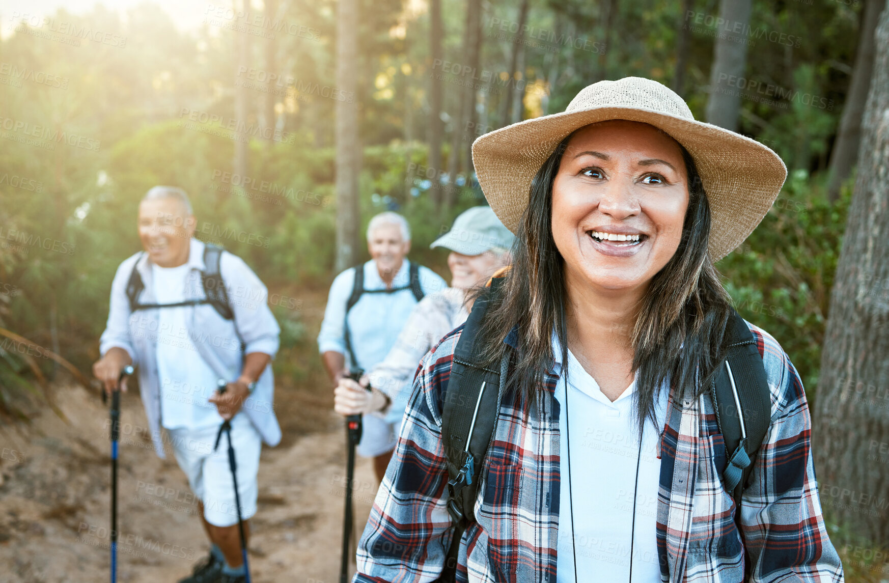 Buy stock photo Hiking, adventure and exploring with a senior woman and her retired friends on a hike outdoors in nature. Enjoying a walk or journey of discover in the forest or woods for leisure and recreation