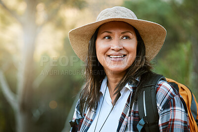 Buy stock photo Hiking, adventure and exploring with a mature female hiker enjoying a walk or hike in the forest or woods outside. Senior woman walking on a journey of discovery in nature in the great outdoors
