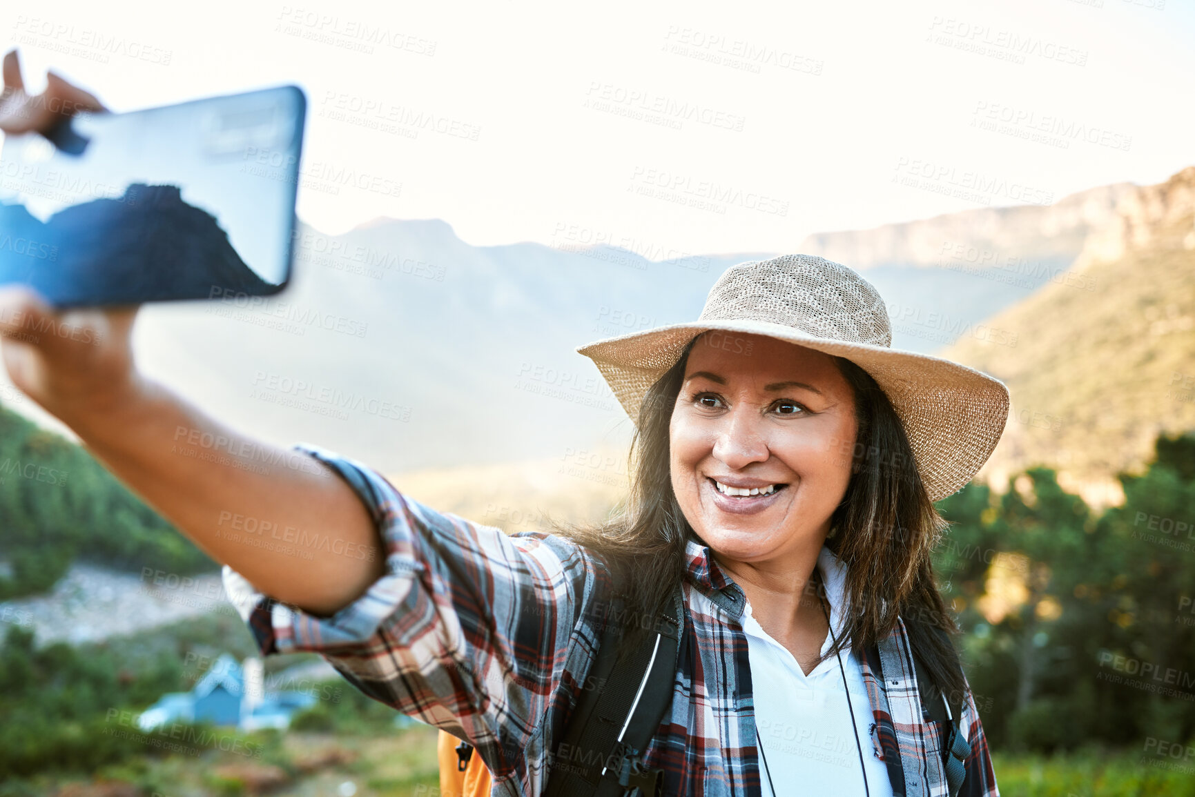 Buy stock photo Hiking, tourist and woman taking selfies, photo and video call for social media while exploring, travel and sightseeing in nature outdoors. Happy, active and free female enjoying scenic fresh hike