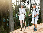 Hiking, adventure and exploring with a senior couple or friends having fun, exercising and enjoying the outdoors. Walking, discovering and journey with old people talking in nature, forest or woods