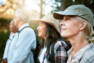 Buy stock photo Hiking, adventure and exploring with a group of senior friends enjoying a walk or nature hike in the forest or woods outdoors. Closeup of mature retired people on a journey for outside discovery.
