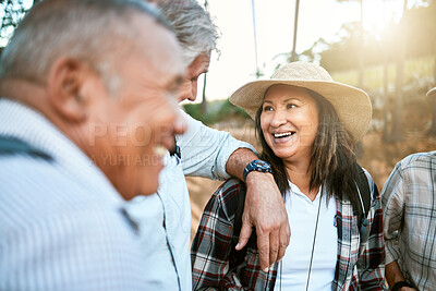 Buy stock photo Happy senior woman in nature with friends while taking an outdoor walk in spring. Smiling mature woman having a conversation with a man outside. Old smiling lady having fun while hiking with aged men