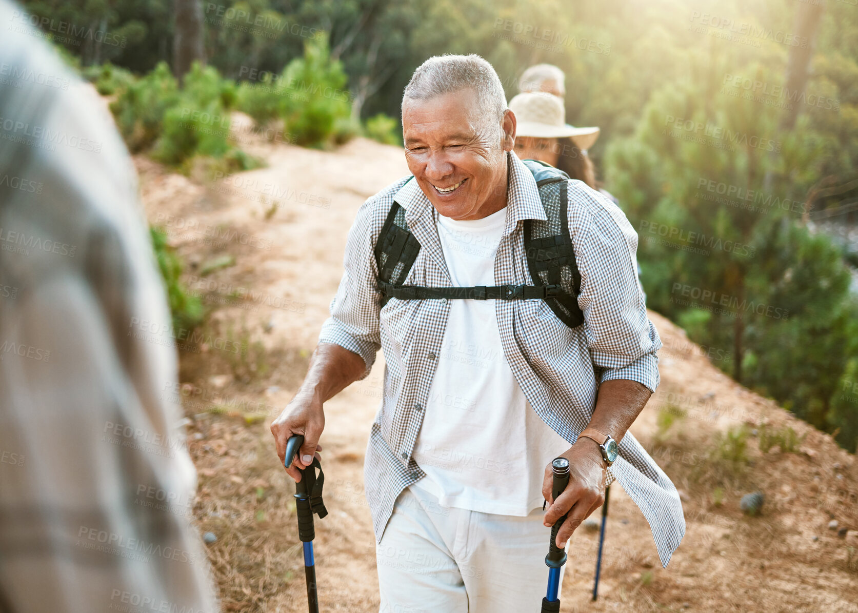 Buy stock photo Hike, trekking sticks and senior male walking with friends for fitness and health in nature. Healthy, active and smiling mature man hiking with a backpack. Old group on an outdoor wellness adventure