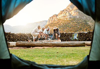 Buy stock photo People camping with a tent and roast marshmallows on a campfire enjoy outdoors, nature and the wild. Fresh air, adventure and travel lifestyle campers on a campsite relax and bond on wellness retreat
