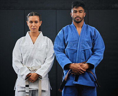Fitness, motivation and discipline karate training with a student and teacher standing proud in a center or dojo. Young woman learning defense, strength and endurance lesson from martial arts coach