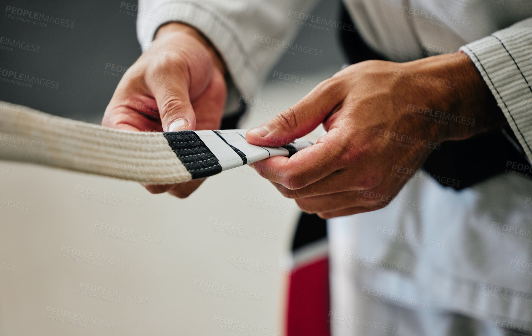 Buy stock photo Fitness, training and karate teacher hands prepare uniform for new student at a center or dojo. Martial arts sensei getting ready to lead a lesson on self defense, speed and physical endurance