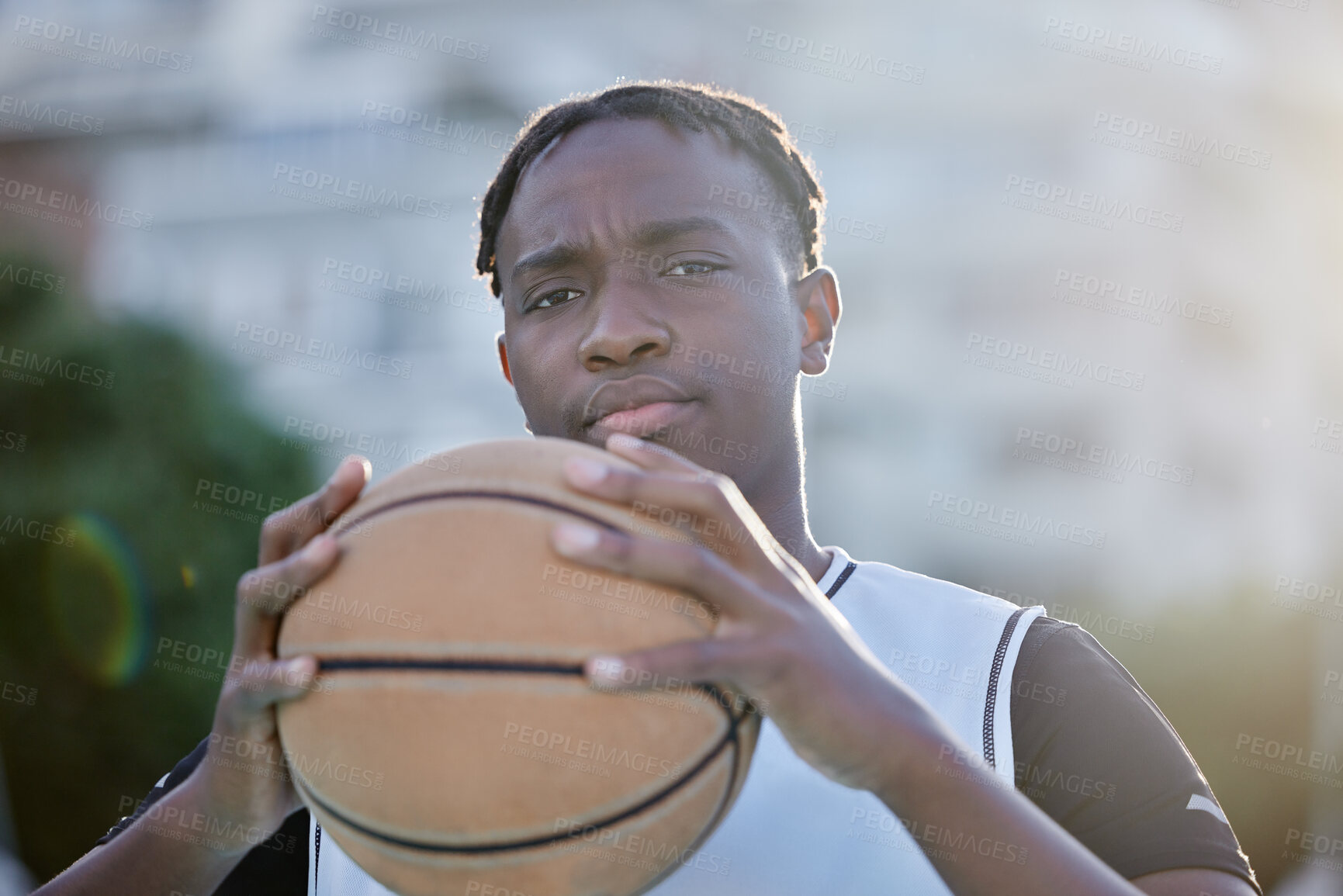 Buy stock photo Basketball, cool and a tough player training for a game on a basketball court. Portrait of a serious professional athlete focused on his sport career, looking ready, powerful and assertive