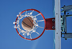 Basketball sports winner throwing, shooting hoops and slam dunk for points, score and performance during sports, competition and game match from below outdoor. Background of net, hoop and goal target