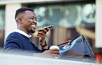 Happy black man talking on phone, travel for business in a city, sitting outside while using tech to communicate. Carefree African American planning, asking Siri assistance, voice to text audio memo