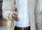Businessman hands with a handshake greeting or deal on collaboration with a b2b agreement. Closeup of a successful African man working in management welcoming a corporate partnership during interview