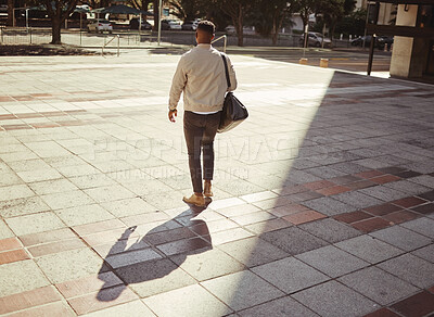 Buy stock photo Business, travel and city with a young man walking outdoors against an urban background in the day. Entrepreneur or employee looking for work, a job or ready to start a career on a summer morning