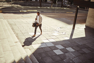 Buy stock photo Style, travel and a fashion young man walking in a empty city or urban town. Corporate african american man or business traveler traveling in an urban town with good style and trendy going to a hotel