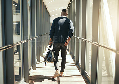 Buy stock photo Businessman at airport walking for work travel and male african morning commute to city. Transport service from airplane terminal to hotel, rear view of modern worker carrying hand luggage bag trip.