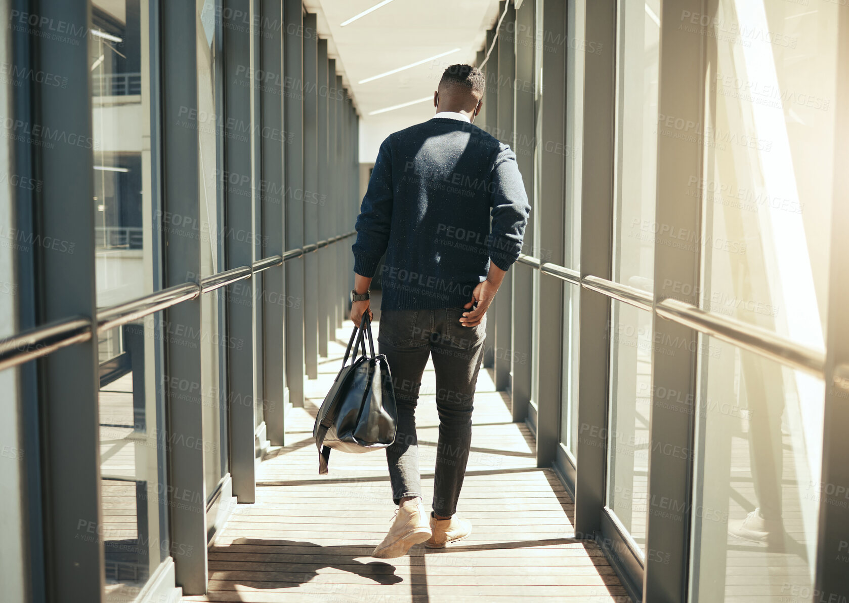 Buy stock photo Businessman at airport walking for work travel and male african morning commute to city. Transport service from airplane terminal to hotel, rear view of modern worker carrying hand luggage bag trip.