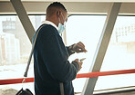 Travel businessman with covid face mask on his way to corporate or business opportunity in the city. Young black business man checking time, running late due to covid 19 airport delay and compliance