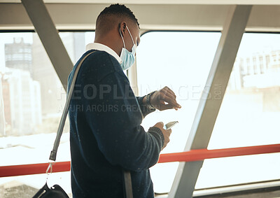 Buy stock photo Travel businessman with covid face mask on his way to corporate or business opportunity in the city. Young black business man checking time, running late due to covid 19 airport delay and compliance