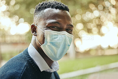 Buy stock photo Face, mask and covid of a black businessman in the city for health and safety in the outdoors. Portrait of a happy man in a pandemic alone outside in nature with mockup background.