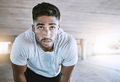 Buy stock photo Fitness athlete tired from workout, exercise and training for health, wellness and sport cardio outdoor. Young man runner rest and relax after a healthy running or sports challenge in a urban city