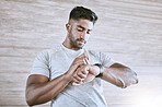 Man with digital smartwatch for health, fitness and performance progress tracking after exercise or training. Strong and healthy young man or athlete check with tracker watch for time and heart pulse