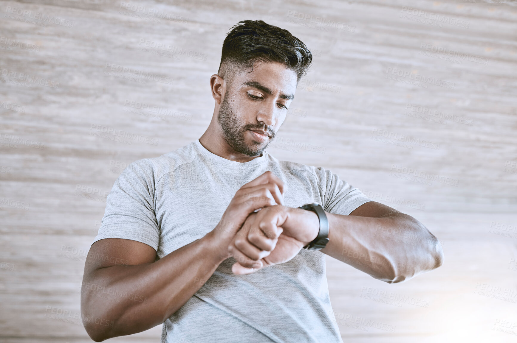 Buy stock photo Man with digital smartwatch for health, fitness and performance progress tracking after exercise or training. Strong and healthy young man or athlete check with tracker watch for time and heart pulse