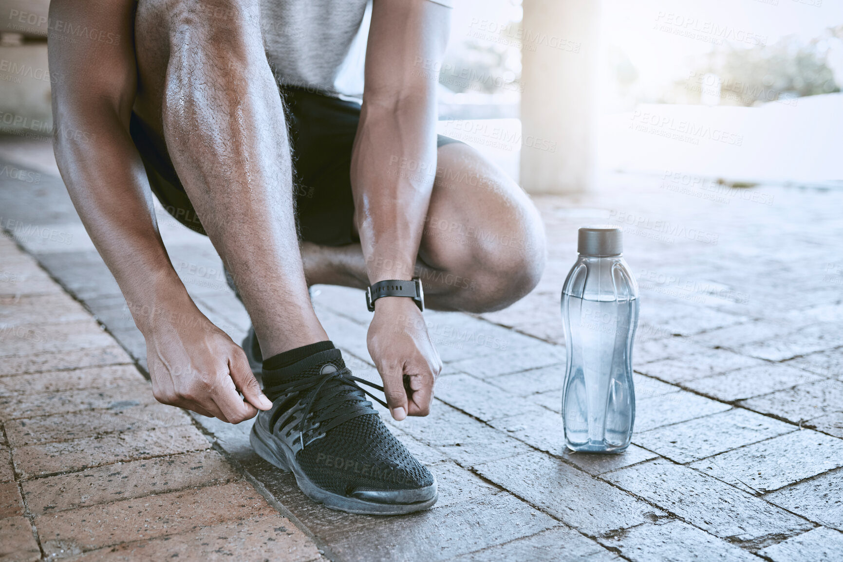 Buy stock photo Shoes, water bottle and hand of runner for motivation and in fitness training in city street. Start workout exercise for sport run on road in town. Running athlete foot prepare for wellness and sport