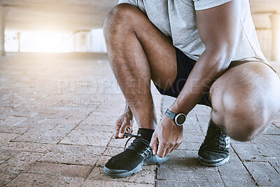 Buy stock photo Shoes, running and sports with a man in training, workout and exercise for health, wellness and fitness in the city. Motivation with a runner tying his laces before a performance run for cardio