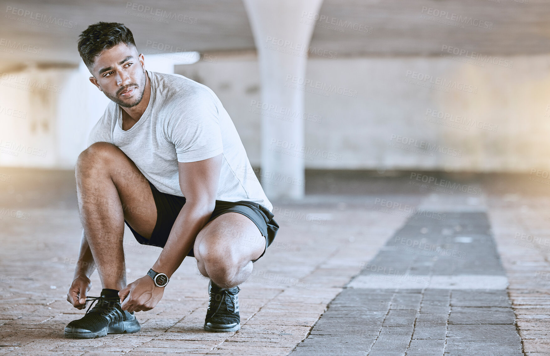 Buy stock photo Fitness, running and exercise, a man going on a run in the city. Motivation, cardio and training, a runner lacing his sports shoes before an outdoor workout for a healthy body and an active lifestyle