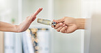 Person refusing to accept a cash bribe payment from a corrupt financial business partner. Closeup of hands offended by illegal money being offered for a corporate deal by a company manager at work.